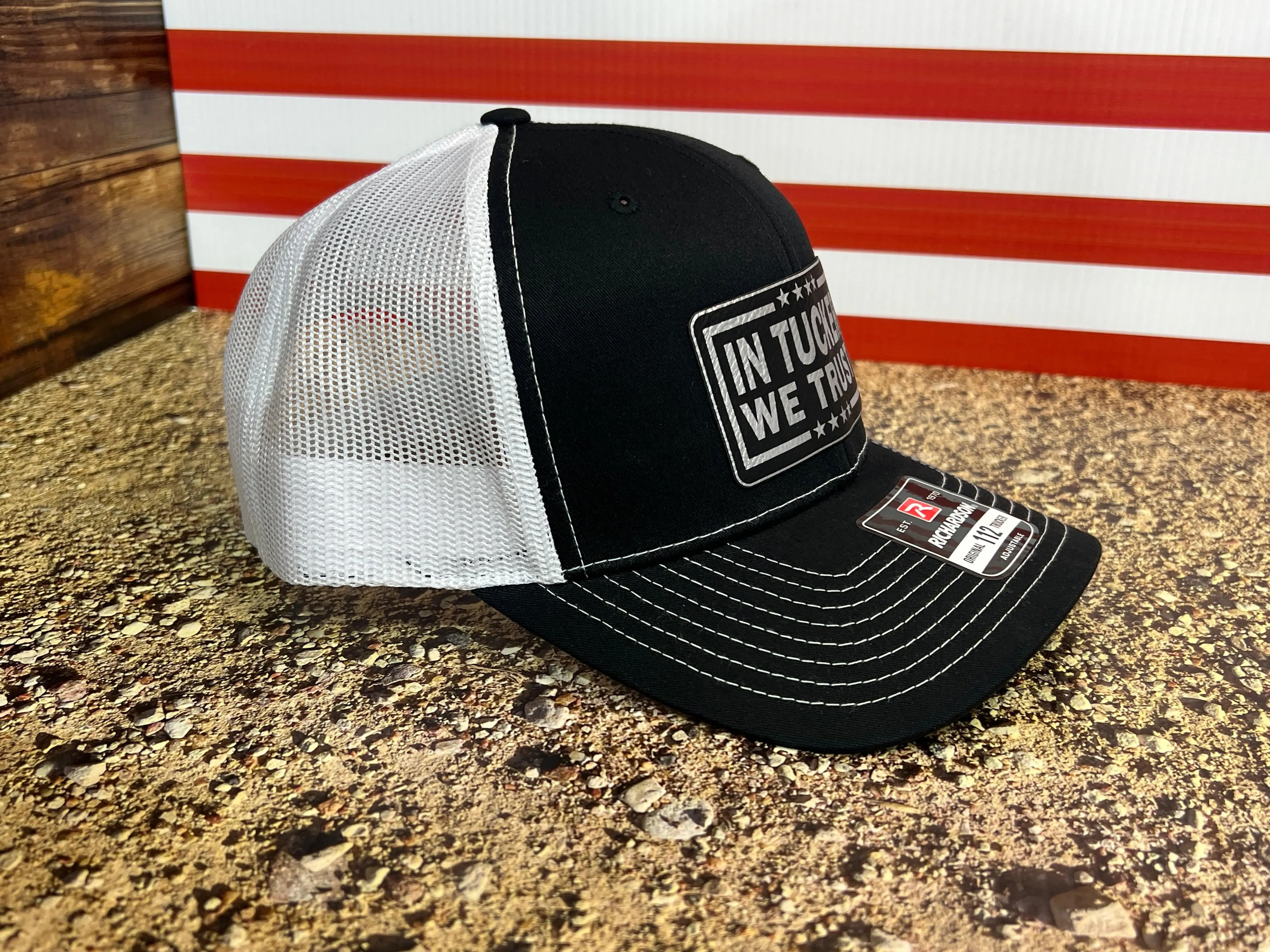 In Tucker We Trust Hat with Laser Engraved Premium Leatherette Patch on a Richardson 112 Trucker Hat.