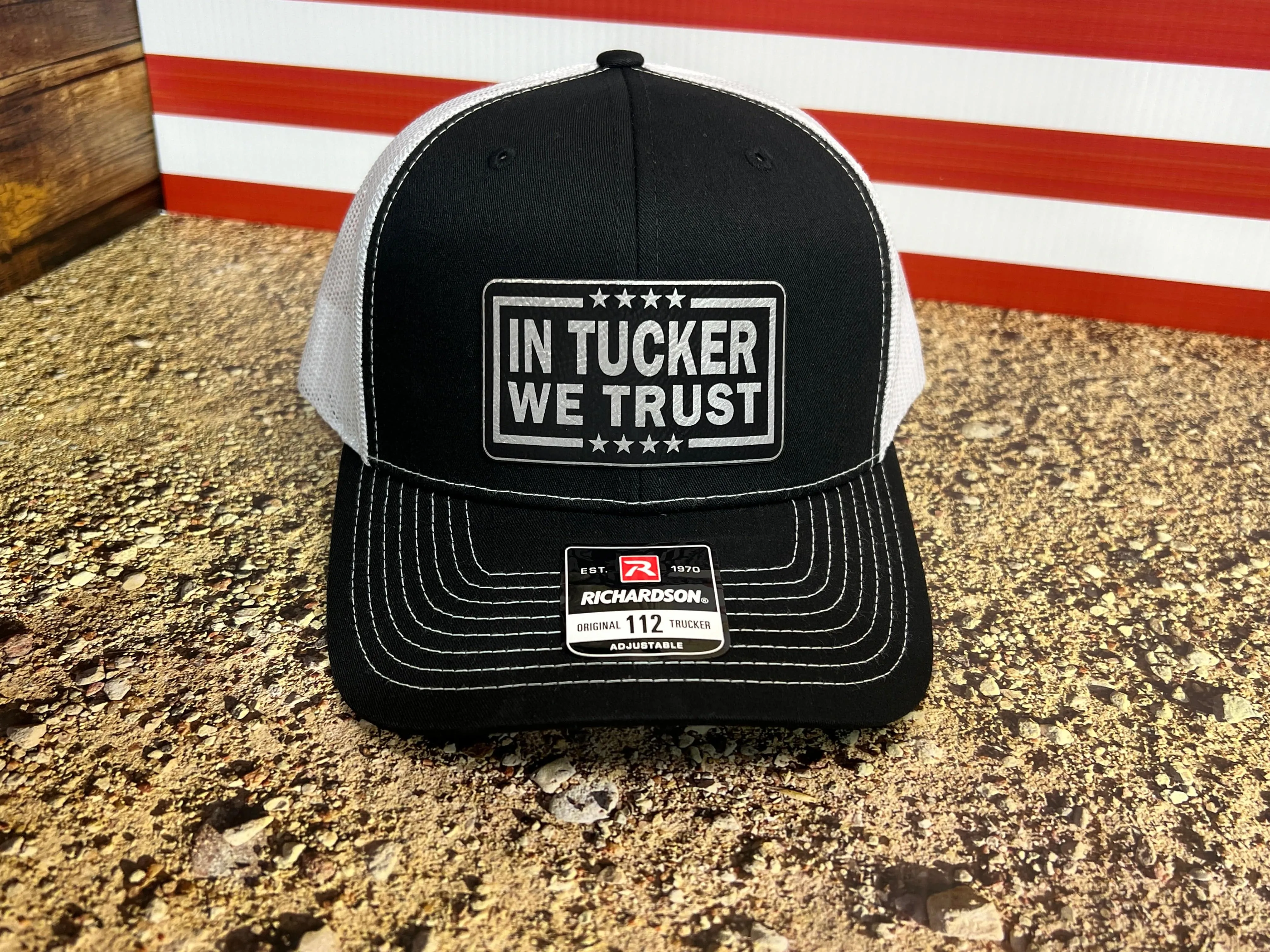 In Tucker We Trust Hat with Laser Engraved Premium Leatherette Patch on a Richardson 112 Trucker Hat.